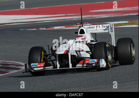 Japanese Formula One race driver Kamui Kobayashi of Sauber is pictured during a test run at the Circuit de Catalunya race track in Montmelo near Barcelona, Spain, 18 February 2011. Photo: David Ebener Stock Photo