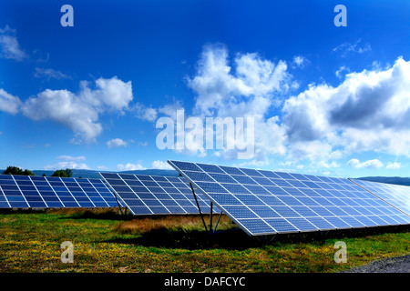 Solar panels producing renewable energy in a large array at a solar farm. Auvergne. France Stock Photo