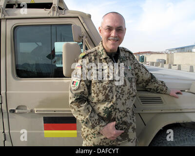 The commander of the regional army command 'Nord' (North) of the German Bundeswehr in Afghanistan, major general Hans-Werner Fritz, leans against an army vehicle at the German military camp in Mazar-i-Sharif, Afghanistan, 20 February 2011. Despite the deadly attack of an Afghan soldier on the German Bundeswehr, there was no alternative to the current collaboration (Partnering) betw Stock Photo