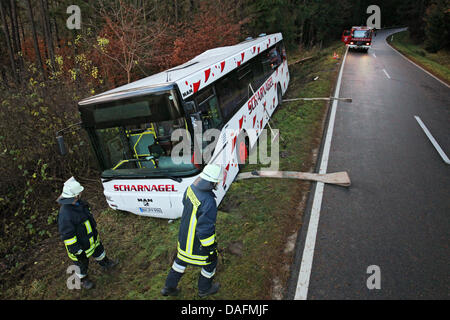 A bus lies in the ditch on a road near Herrieden, Germany, 05 December 2011. Seven children were injured in the school bus accident in the morning. According to the police, the bus straited from the street due to unknown reasons. Photo: DANIEL KARMANN Stock Photo