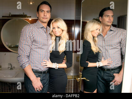 Swedish top model Marcus Schenkenberg poses with his US American girlfriend Dorin in Berlin, Germany, 24 November 2011. Photo: Joerg Carstensen Stock Photo