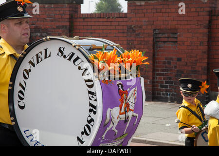 Southport, UK 12th July, 2013.    Colonel Saunders Drummer at the Orangemen's Day parade assembling in London Street.  A number of Orange Order lodges accompanied by pipe and drum marching bands gathered in Southport for the annual Orange Day marches.  July 12 is the most important day of the loyalist calendar, when members of the Orange Lodge march to commemorate the 1690 Battle of the Boyne in Ireland.  Credit:  Conrad Elias/Alamy Live News Stock Photo