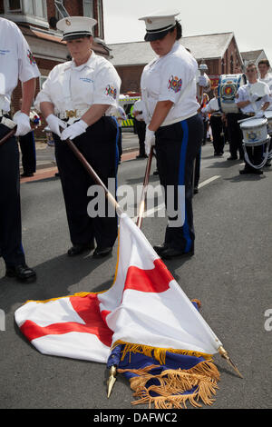 Southport, UK 12th July, 2013.   Draped flags and a minutes silence at the Orangemen's Day parade assembling in London Street.  A number of Orange Order lodges accompanied by pipe and drum marching bands gathered in Southport for the annual Orange Day marches.  July 12 is the most important day of the loyalist calendar, when members of the Orange Lodge march to commemorate the 1690 Battle of the Boyne in Ireland.  Credit:  Conrad Elias/Alamy Live News Stock Photo