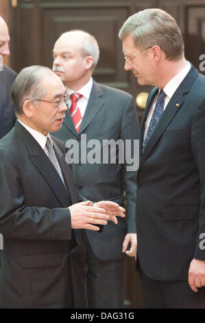 The picture shows German President Christian Wulff (CDU) (R) talking to the Embassador of Japan Takakiro Shinyo (L), during his visit of condolence at the Japanese Embassy in Berlin, Germany on 14 March 2011. PHOTO: TOBIAS KLEINSCHMIDT Stock Photo