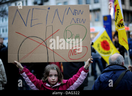 The picture shows a little girl holding a self-made sign at an anti-nuclear vigil in Kassel, Germany on 14 March 2011. Several hundred people commemorated the victims of the earthquake catastrophe in Japan and protested against nuclear power. PHOTO: UWE ZUCCHI Stock Photo