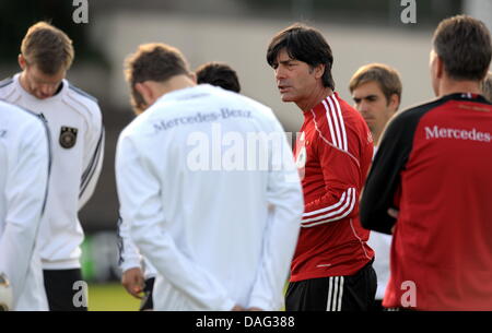 (dpa file) A file picture dated 05 September 2009 of Germany national soccer head coach Joachim Loew (C-R) during a training in Cologne Germany. According to a report of German sports weekly Sport Bild released on 15 March 2011, the contracts of Loew and his staff are to be extended until 2014. Currently, the contracts expire after the UEFA Euro 2012. Photo: FEDERICO GAMBARINI Stock Photo