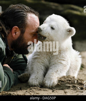 (file) - A dpa file picture dated 23 March 2007 shows beloved polar bear Knut playing with his warden Thomas Doerflein during his first official outing at the zoo in Berlin, Germany. The zoo's bear expert Heiner Kloes reported that the four-year-old polar bear collapsed and died of unknown causes in his compound on 19 March 2011. Knut was one of the zoo's major attractions and popu Stock Photo