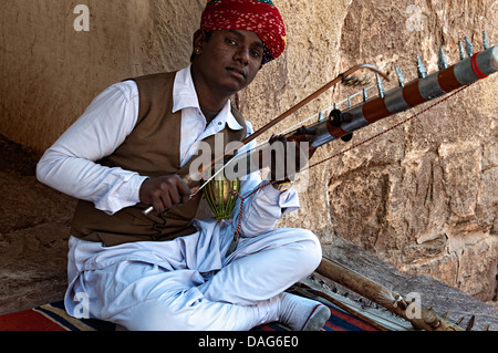Portrait of a man playing a traditional musical instrument in Mehrangarh fort. Jodhpur, Rajasthan, India Stock Photo