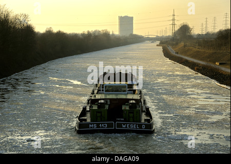 ship on Rhine-Herne Canal in winter, gasometer in background, Germany, North Rhine-Westphalia, Ruhr Area, Oberhausen Stock Photo