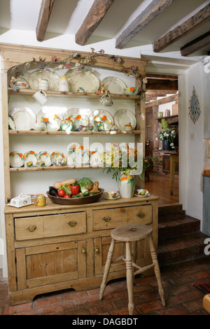 Vintage china on old pine dresser in cottage kitchen Stock Photo