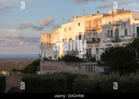 Old buildings in the historic hill town of Ostuni in Apulia, southern Italy, lit by soft summer evening light Stock Photo
