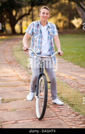 teenage boy riding a bicycle at the park Stock Photo