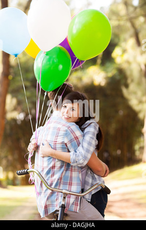 sweet teenage couple hugging outdoors Stock Photo