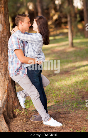 romantic teenage couple embracing outdoors Stock Photo