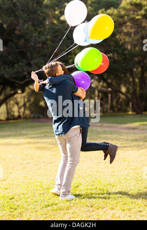 happy teen boy hugging girlfriend outdoors Stock Photo