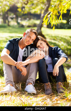 loving young teenage couple sitting outdoors Stock Photo