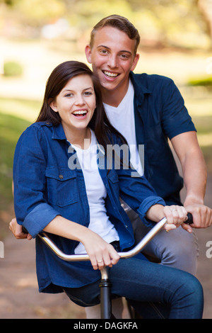 happy teenage couple on a bicycle Stock Photo