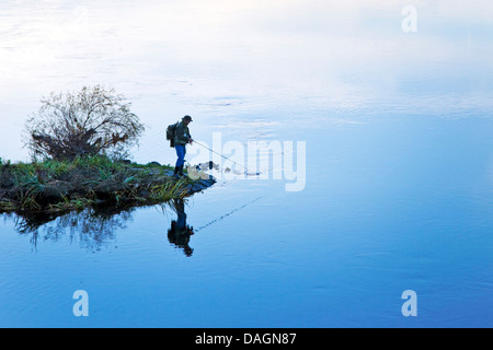 angler standing on Ruhr river dam in evening light, Germany, North Rhine-Westphalia, Ruhr Area, Hattingen Stock Photo