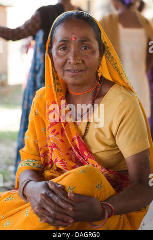 Elderly Tharu Woman in a community meeting hall. Bardia. Bheri Zone, Mid-Western Region, Terai. Nepal. Note dress tilak forehead Stock Photo