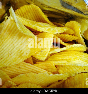 Looking into an open packet of crinkle cut crisps. Stock Photo