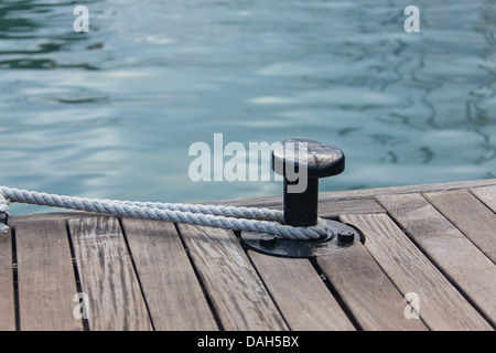 Mooring rope tied around steel anchor Stock Photo