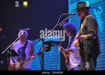 Cologne, Germany. 12th July, 2013. Musician Neil Young stands onstage together with his band 'Crazy Horse' during a concert in Cologne, Germany, 12 July 2013. Photo: HENNING KAISER/dpa/Alamy Live News Stock Photo