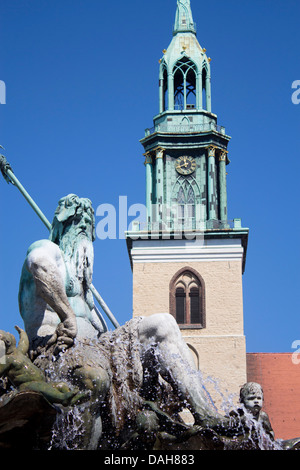 Neptune Statue and Fountain (Neptunbrunnen) and Marienkirche church tower Mitte Berlin Germany Stock Photo