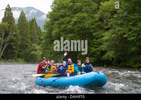 Family enjoying a whitewater rafting trip on the McKenzie River in Oregon Stock Photo