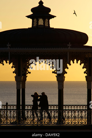 Silhouetted couple dancing on the Victorian bandstand, Brighton seafront. East Sussex, England Stock Photo