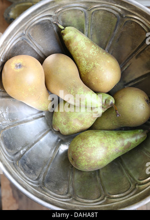 Fresh pears in a metal fruit bowl Stock Photo