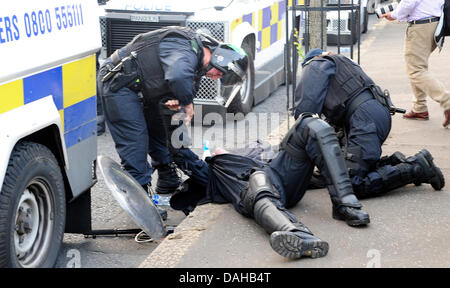 Belfast, UK. 12th July, 2013. A total 32 police were injured in what Chief Constable Matt Baggott described as 'shocking and disgraceful' violence, including head, eye and leg wounds. Another 400 reinforcements were being brought in from Britain. Credit:  andrew chittock/Alamy Live News Stock Photo