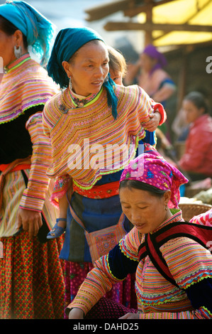 Potrait of a young Flower Hmong woman in distinctive headdress, Can Cau market, N Vietnam. Model Released Stock Photo