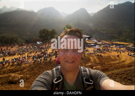 Traveller in Vietnam, with the weekly Can Cau Saturday market behind. Model released Stock Photo