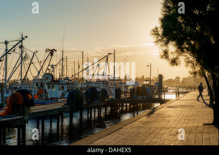 Two men head home after a hard day working at the boat harbour in Lakes Entrance, Victoria. Stock Photo