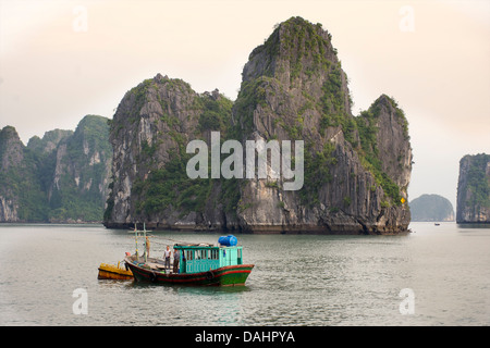 Small Vietnamese fishing boat between Halong Bay and 'Cat Ba' Island, Vietnam Stock Photo