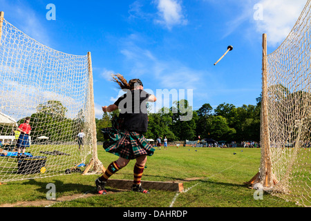 Competitor at Scottish highland games throwing the 22 pound hammer, a traditional Scottish competition. Stock Photo
