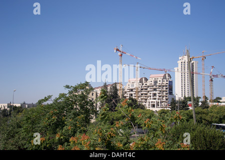 Construction cranes over new apartment buildings Stock Photo
