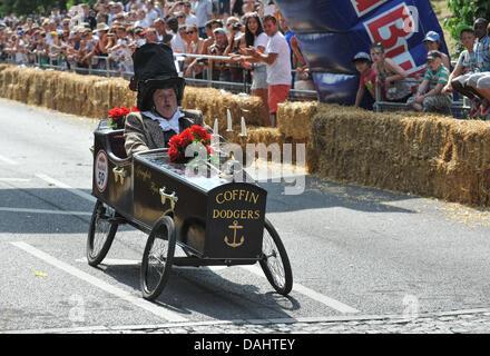 Alexandra Palace, London, UK. 14th July 2013. One of the Red Bull Soapbox racers 'The Coffin Dodgers' finishes the race at Alexandra Palace. The Red Bull Soapbox Race at Alexandra Palace, is an international event in which amateur drivers race homemade soapbox vehicles. 'Each hand-made machine is fuelled by nothing but sheer courage, the force of gravity and perhaps a little Red Bull. Credit:  Matthew Chattle/Alamy Live News Stock Photo