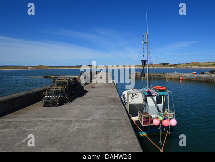 Fishing Boat & Lobster Pots in the Harbour at Beadnell on St Oswalds Way Long Distance Footpath Northumberland Coast Stock Photo
