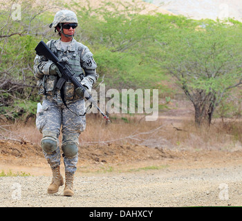 U.S. Army Spc. Wilma Orozco conducts a patrol while attending the Warrior Leader Course, April 22, 2013, at Fort Allen's 201st Regional Training Institute in Juana Diaz, Puerto Rico Stock Photo