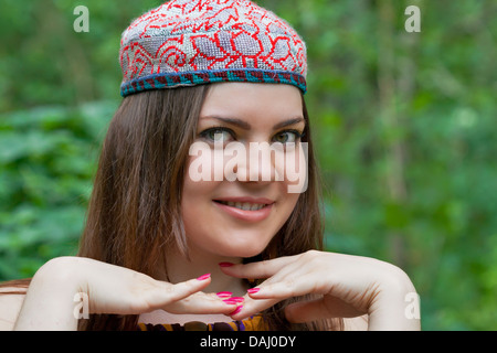 Young pretty green eyes woman posinn in a skullcap closeup Stock Photo