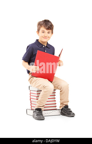 Boy with pile of books in library Stock Photo - Alamy