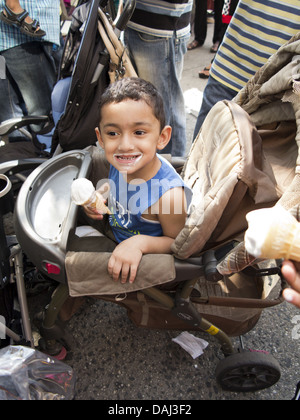 Young boy eating ice cream at Bangladeshi street fair and festival in 'Little Bangladesh,' in Brooklyn, New York, 2013. Stock Photo