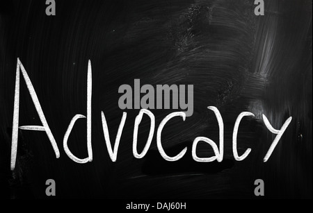 The word 'Advocacy' handwritten with white chalk on a blackboard Stock Photo