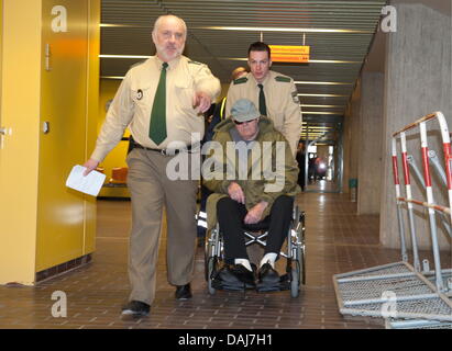 The picture shows John 'Iwan' Demjanjuk being pushed in his wheel chair at the continuation of the trial at the district court in Munich, Germany on 23 March 2011. The former overseer of the NS extermination camp in Sobibor   John Demjanjuk is being charged with assecory to murder. Lawyers of the joint plaintiffs are in agreement that Demjanjuk is responsible for the deaths of memb Stock Photo