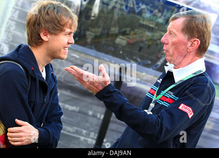 The picture shows the German Formula One driver Sebastian Vettel of Red Bull talking with former World Rally Champion, German Walter Roehrl, in the paddock of the Australian Formula 1 Grand Prix at the Albert Park circuit in Melbourne, Australia on 27 March 2011. Photo: Jens Buettner Stock Photo