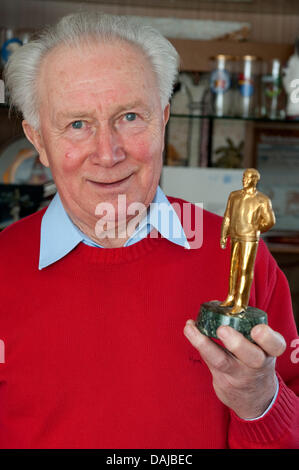 Cosmonaut Sigmund Jaehn is pictured with a small figurine of Yuri Gagarin in Strausberg, Germany, 08 March 2011. Jaehn was the first German person to fly to space with the Soyuz 31 space flight in 1978. Photo: Robert Schlesinger Stock Photo