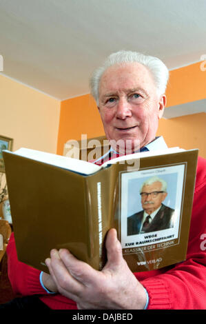 Cosmonaut Sigmund Jaehn is pictured with the book 'Ways to Spaceflight' written by Hermann Oberth in Strausberg, Germany, 08 March 2011. Jaehn was the first German person to fly to space with the Soyuz 31 space flight in 1978. Photo: Robert Schlesinger Stock Photo