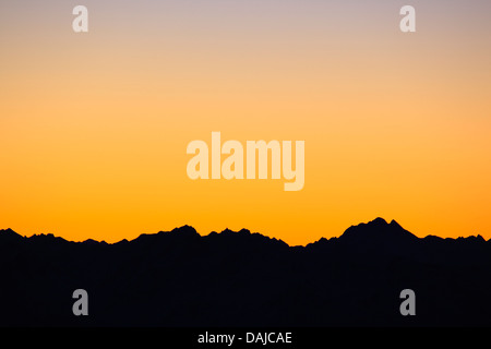 view from Saentis (2502 m) in the Alpstein after sunset with mountain silhouettes and red evening sky, Switzerland, Appenzeller Alpen Stock Photo