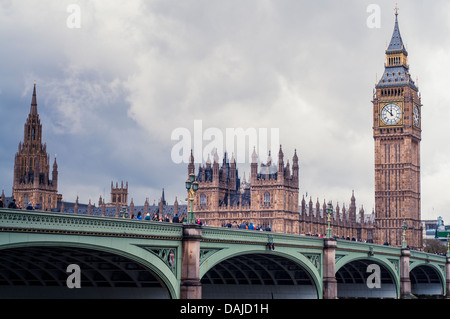 Big Ben, Westminster and the Westminster bridge, London, under a grey stormy sky Stock Photo